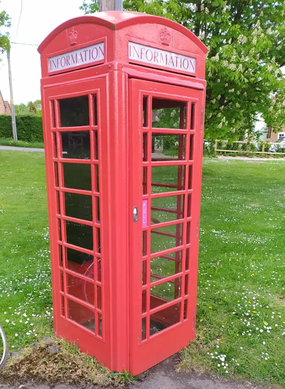 Image of red phone box on the Dunsden green